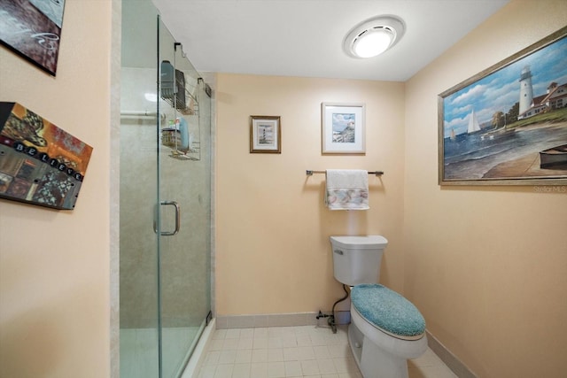 bathroom featuring a shower with door, toilet, and tile patterned flooring