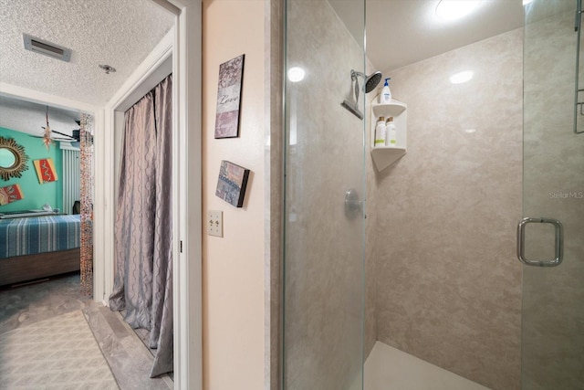 bathroom with tile patterned floors, a textured ceiling, and an enclosed shower