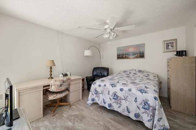 bedroom with built in desk, ceiling fan, and a textured ceiling