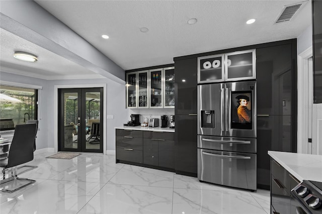 kitchen with stainless steel fridge with ice dispenser, french doors, a textured ceiling, and ornamental molding