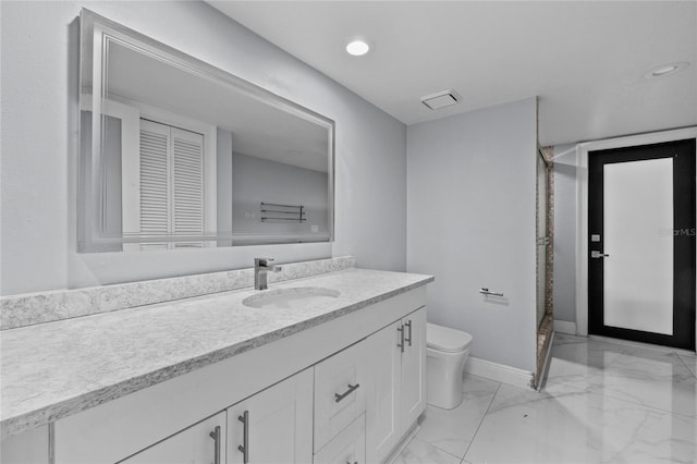 bathroom with vanity, a shower with shower door, and toilet