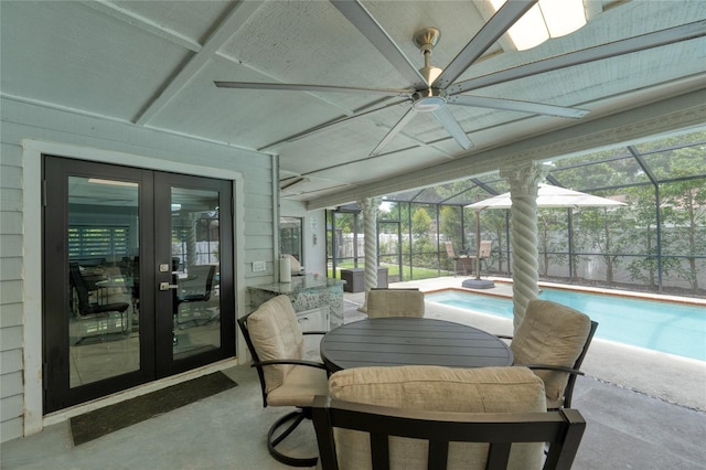 sunroom / solarium with french doors, ceiling fan, and a swimming pool