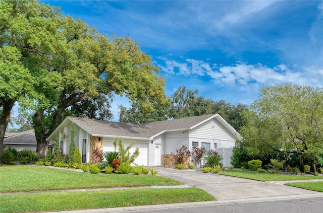 ranch-style house with a garage and a front yard