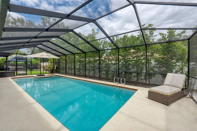 view of swimming pool featuring a lanai and a patio area