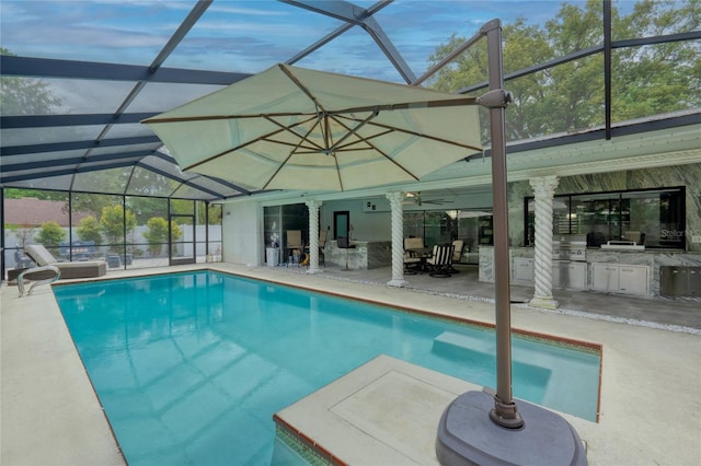 view of pool featuring ceiling fan, area for grilling, a patio, and glass enclosure