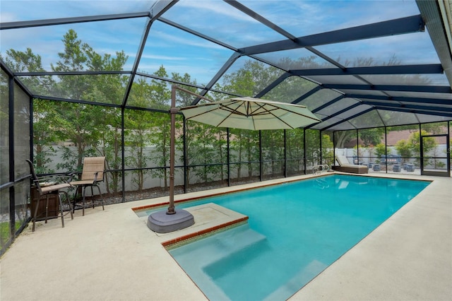 view of pool featuring glass enclosure and a patio area