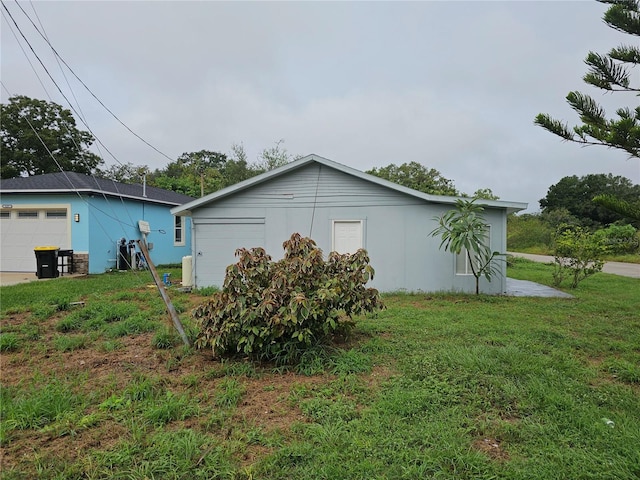 view of home's exterior featuring a yard and a garage