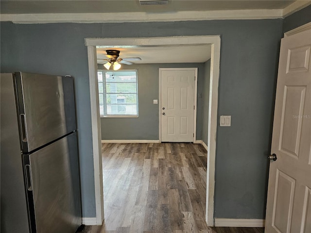 kitchen with hardwood / wood-style floors, ceiling fan, and stainless steel refrigerator