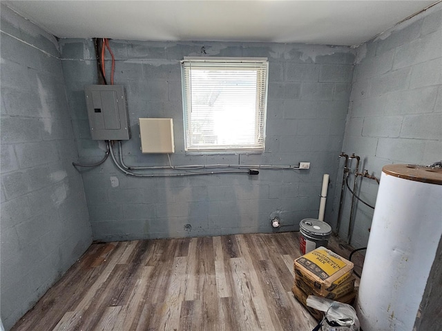 interior space with hookup for a washing machine, hardwood / wood-style floors, electric panel, and gas water heater