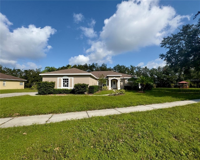 view of front of home featuring a gazebo and a front lawn