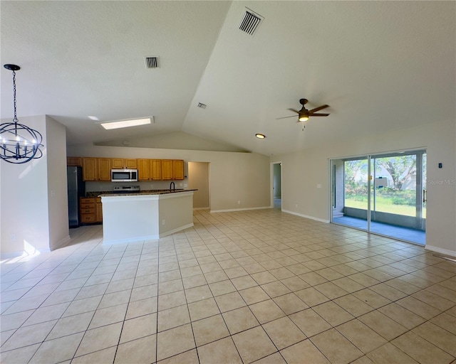 unfurnished living room with lofted ceiling, sink, ceiling fan with notable chandelier, and light tile patterned floors