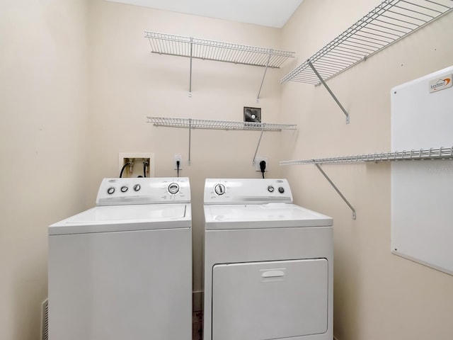 washroom with separate washer and dryer