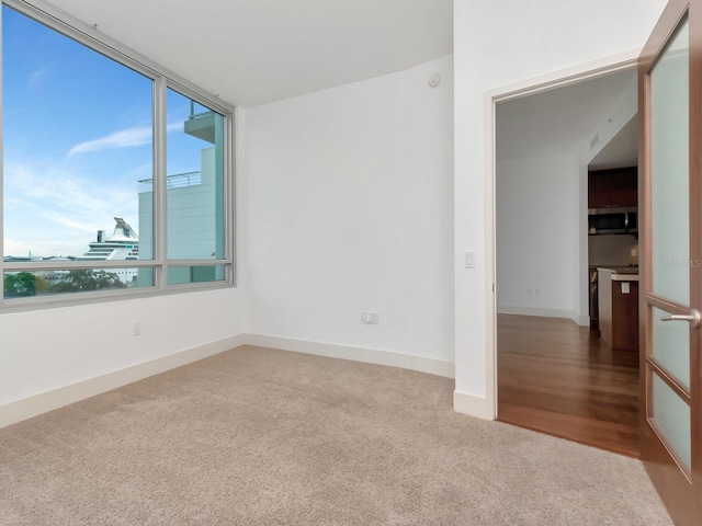 unfurnished room featuring hardwood / wood-style flooring