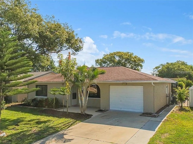 view of front of home with a garage and a front lawn