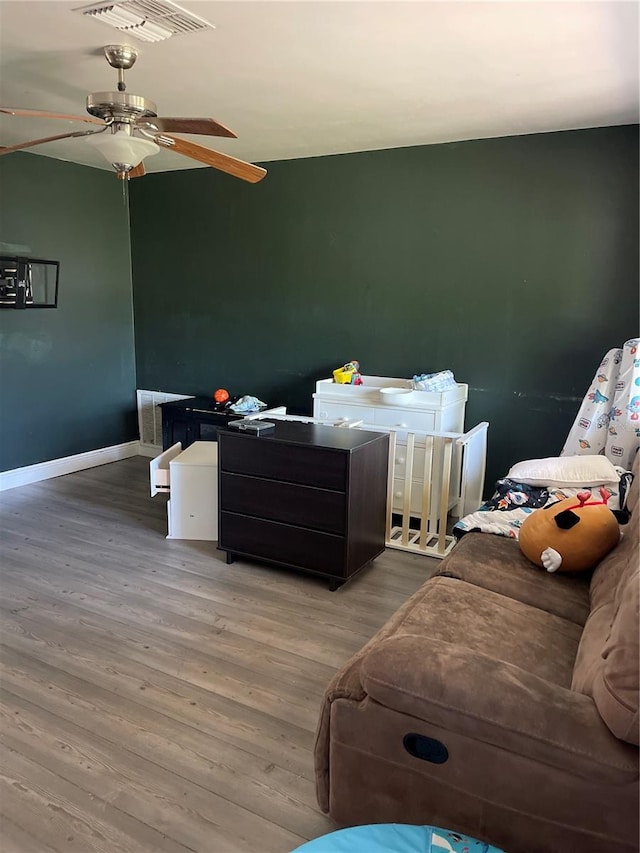 bedroom featuring hardwood / wood-style flooring and ceiling fan