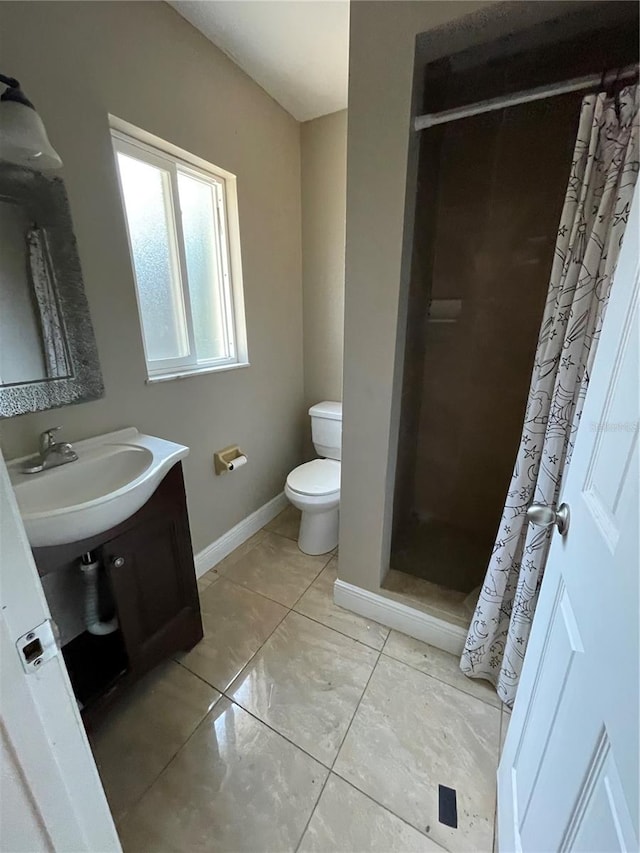 bathroom featuring toilet, a shower with curtain, vanity, and tile patterned flooring