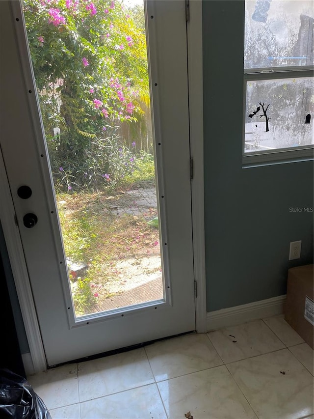 doorway to outside featuring light tile patterned floors