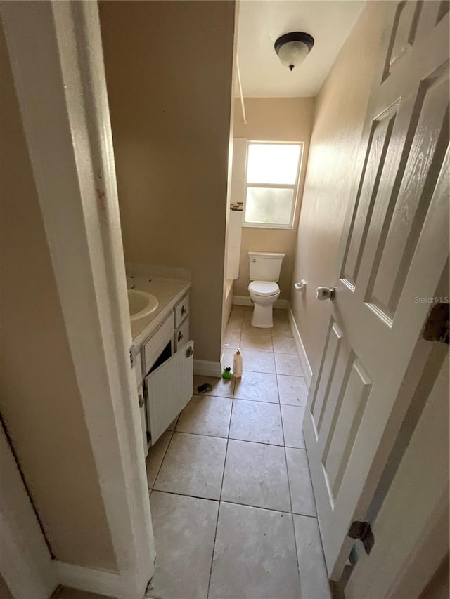 bathroom featuring vanity, toilet, and tile patterned flooring