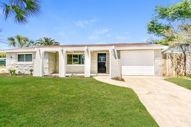 ranch-style house featuring a front yard and a garage