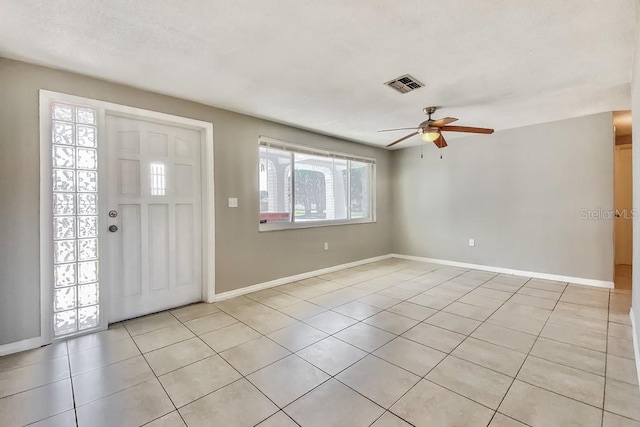 foyer with ceiling fan and light tile patterned floors