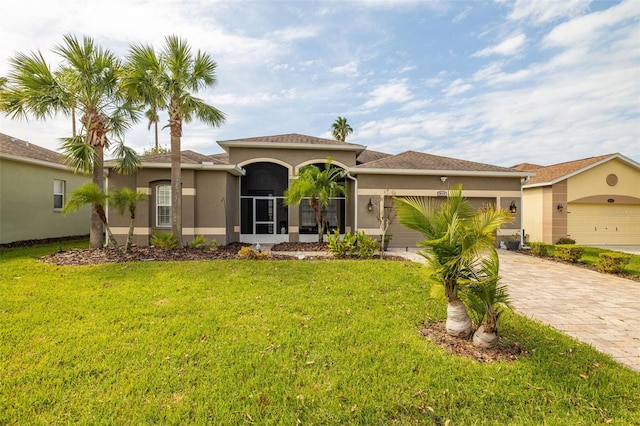 mediterranean / spanish home with a garage and a front lawn