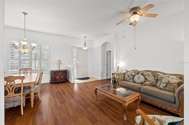 living room featuring hardwood / wood-style floors and ceiling fan with notable chandelier