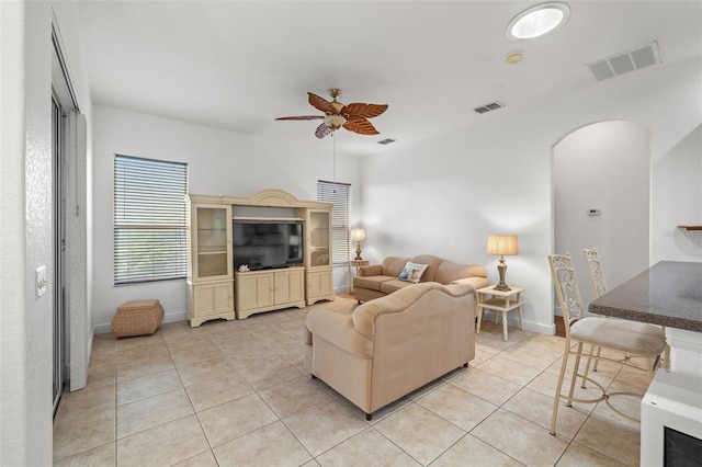 tiled living room featuring ceiling fan