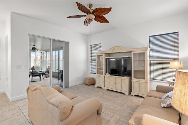 tiled living room featuring a healthy amount of sunlight and ceiling fan