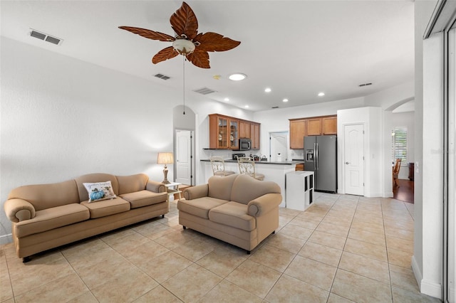 living room featuring light tile patterned floors and ceiling fan