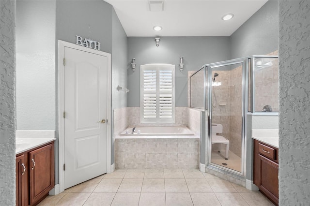 bathroom featuring vanity, independent shower and bath, and tile patterned flooring