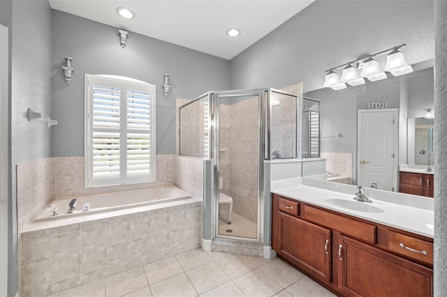 bathroom featuring vanity, tile patterned floors, and separate shower and tub