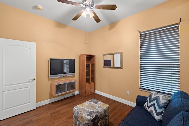 living room with ceiling fan and dark hardwood / wood-style floors