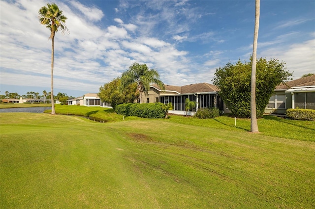 view of yard with a water view and a sunroom