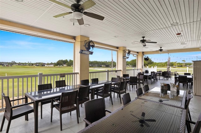 deck with a patio area, a lawn, and ceiling fan