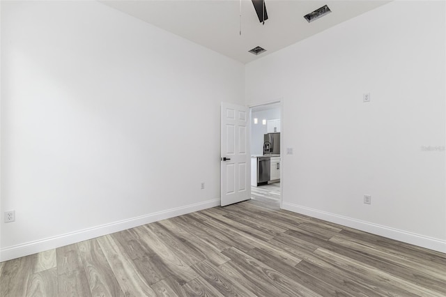 spare room with ceiling fan and light hardwood / wood-style floors