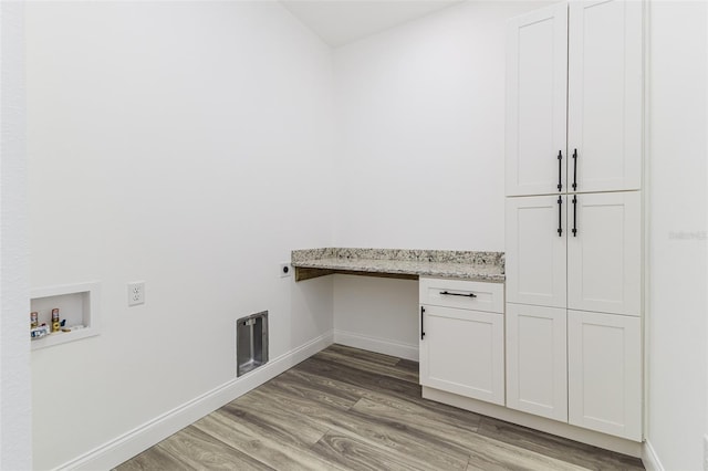 laundry area featuring cabinets, hookup for a washing machine, hardwood / wood-style flooring, and electric dryer hookup