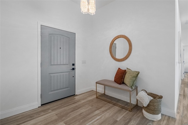 foyer entrance featuring light hardwood / wood-style floors and an inviting chandelier