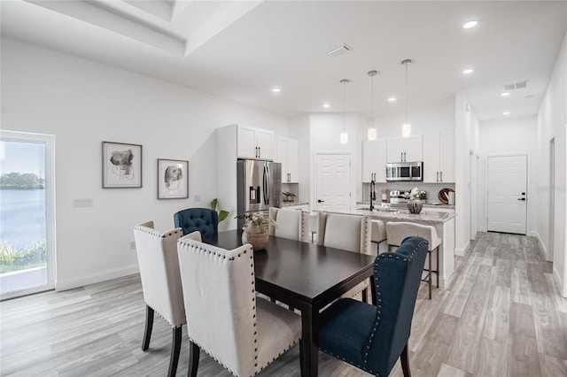 dining space featuring a healthy amount of sunlight and light hardwood / wood-style floors