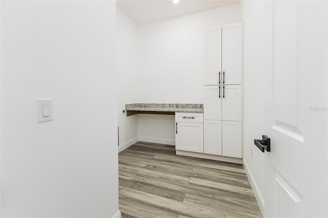 interior space with light wood-style flooring and baseboards