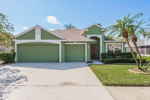 ranch-style house featuring a front lawn and a garage