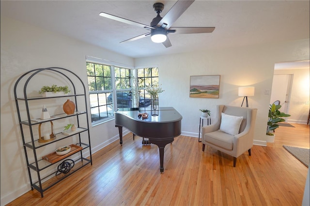 living area featuring ceiling fan and light hardwood / wood-style floors