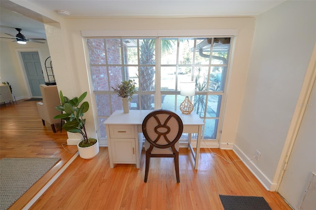 office area with light wood-type flooring and ceiling fan