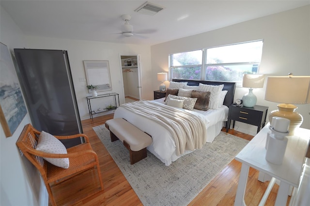 bedroom featuring a closet, ceiling fan, and light hardwood / wood-style flooring