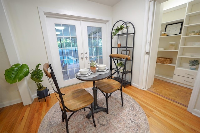 dining room featuring french doors and hardwood / wood-style flooring