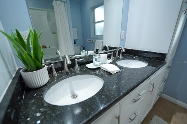 bathroom featuring tile patterned flooring and vanity