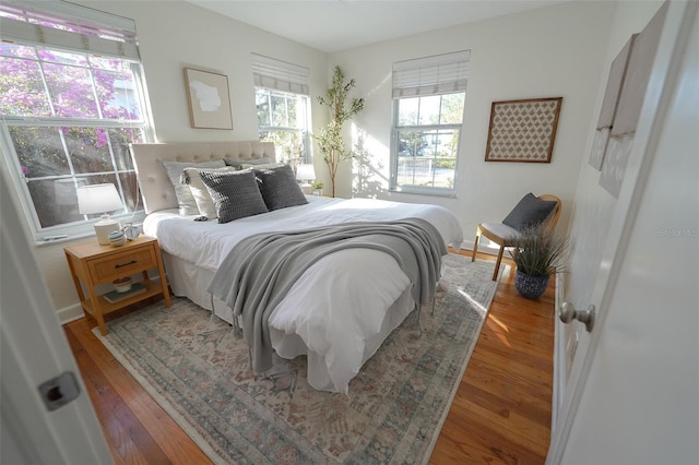 bedroom with hardwood / wood-style flooring