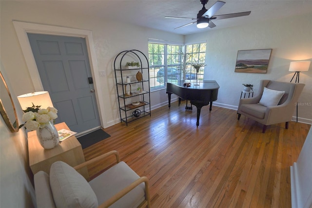 living area featuring hardwood / wood-style flooring and ceiling fan