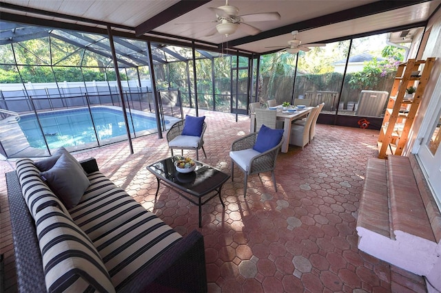 sunroom / solarium featuring ceiling fan and a wealth of natural light