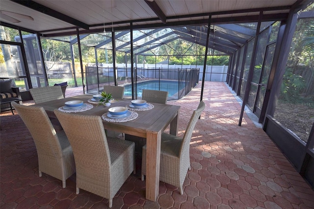 sunroom featuring lofted ceiling with beams