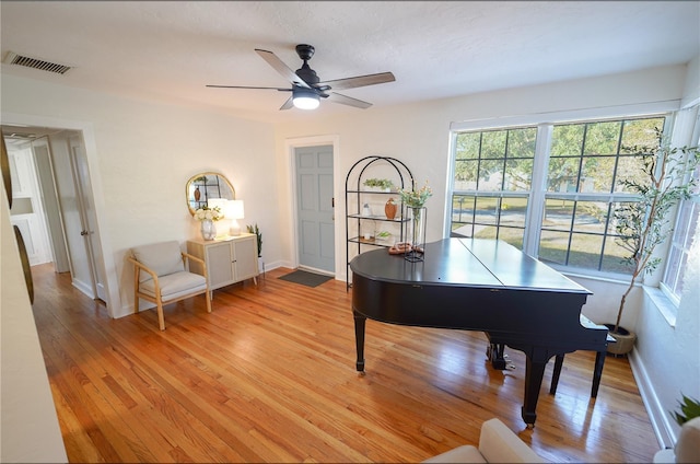 miscellaneous room featuring ceiling fan, a textured ceiling, and light hardwood / wood-style flooring